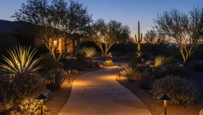 Illuminated walkway with path lights at dusk showcasing professional landscape lighting in Tucson, AZ